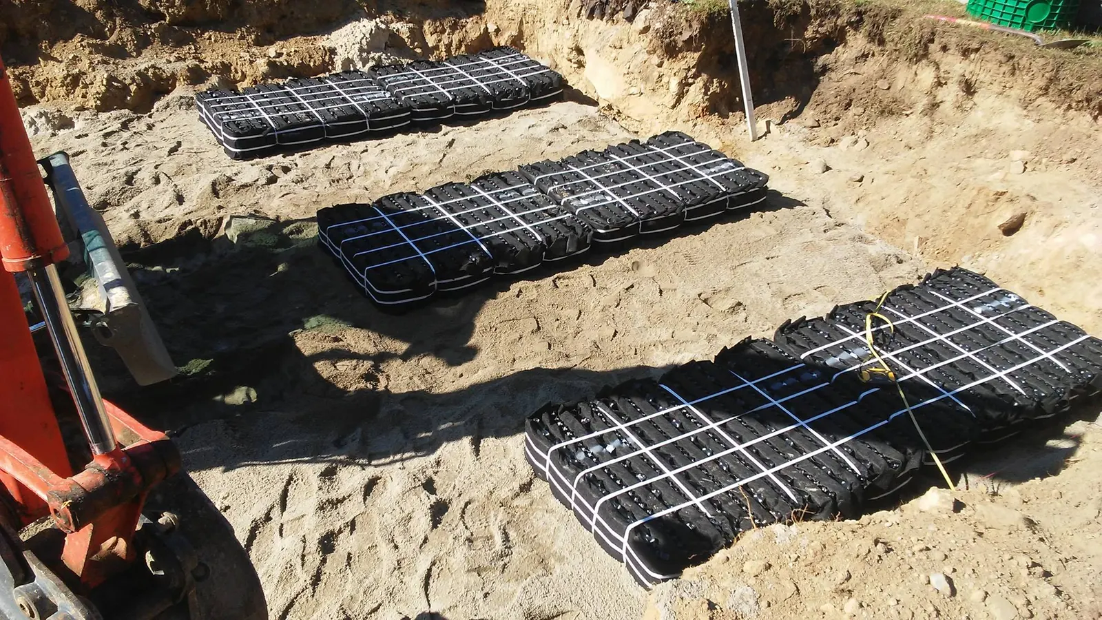 Leach field modules laid in rows on a sand bed at a septic installation