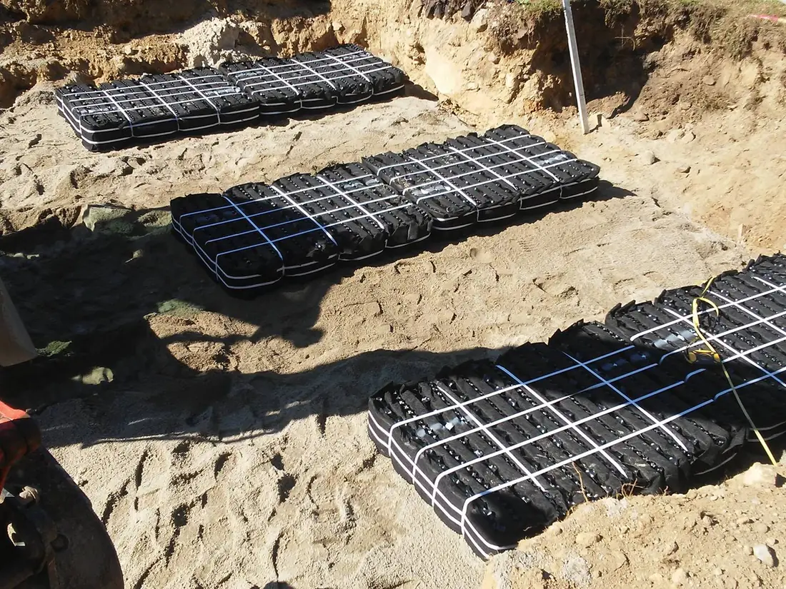 Septic system design laid out in the ground as rows of leach field modules on a sand bed
